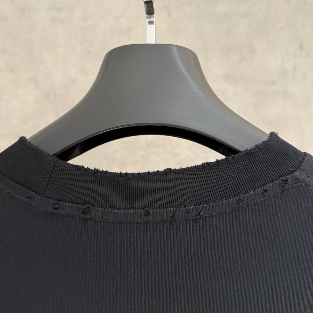 Black crew-neck T-shirt close-up of ribbed collar and neckline