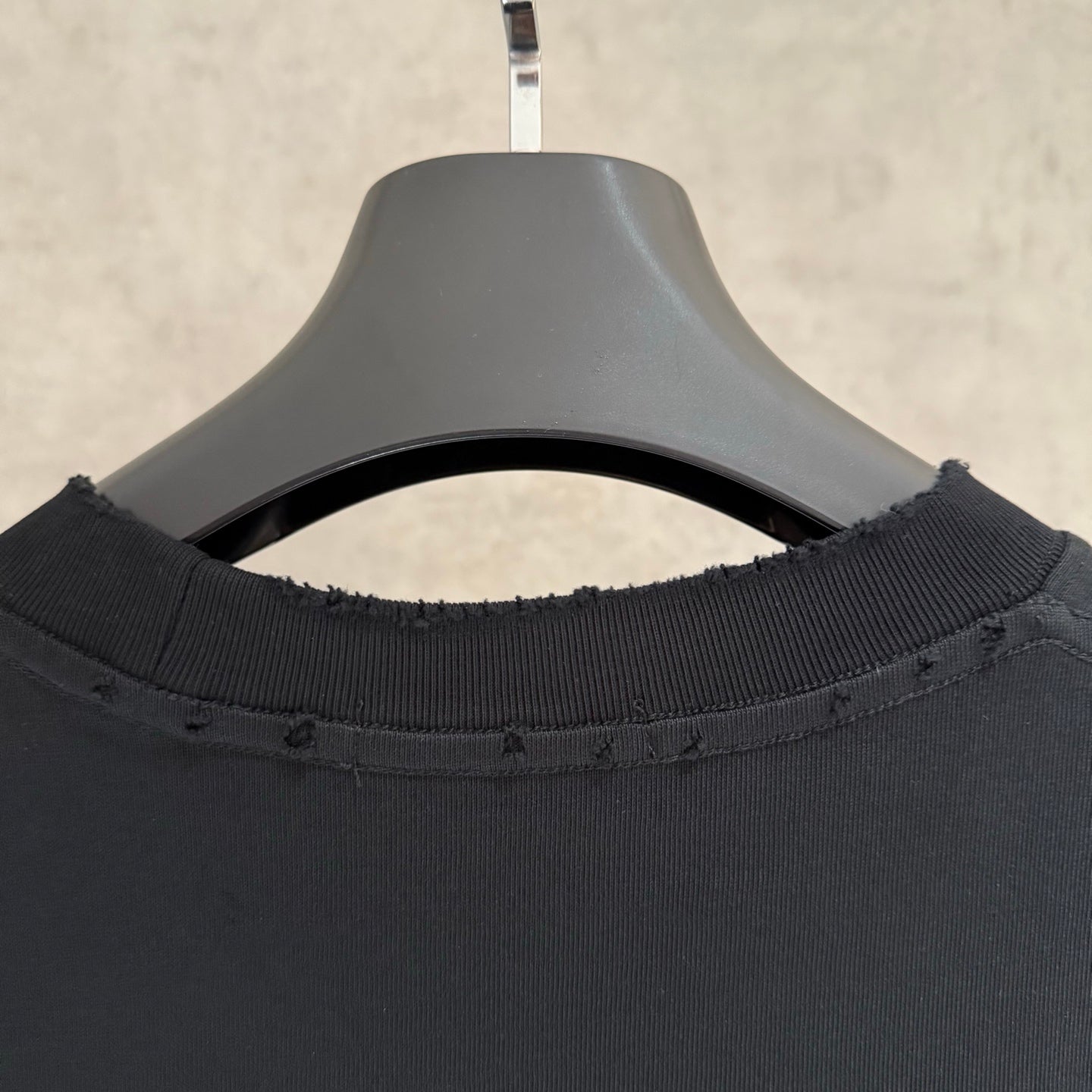 Black crew-neck T-shirt close-up of ribbed collar and neckline