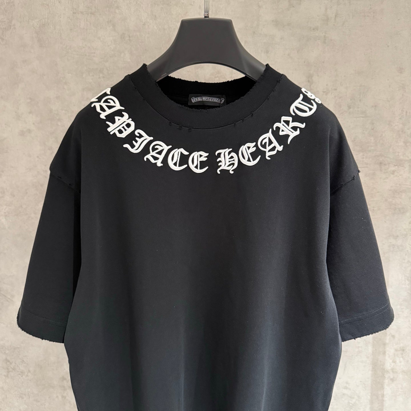 Black short-sleeve T-shirt with white gothic-style chest graphic