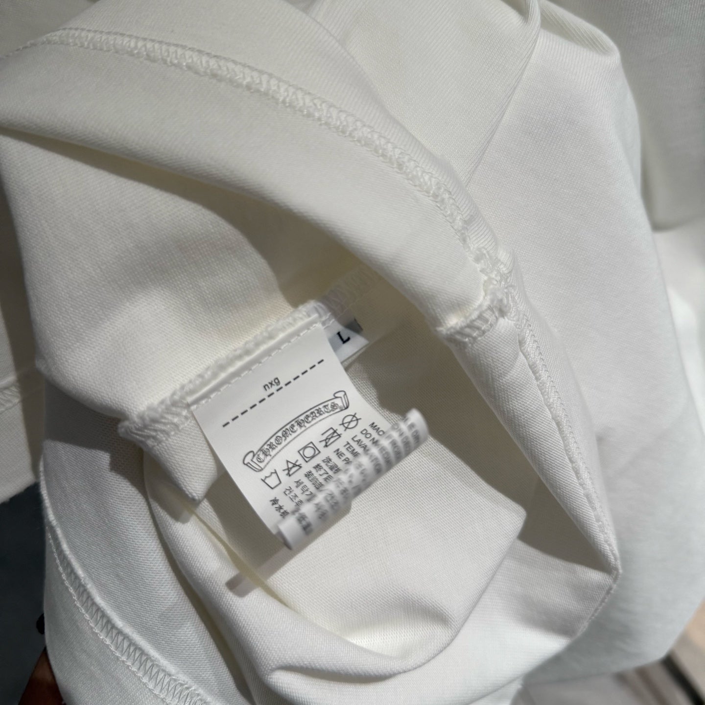 White short-sleeve T-shirt with size label near side seam