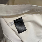 White T-shirt hem with stitched edge and BALENCIAGA care tag