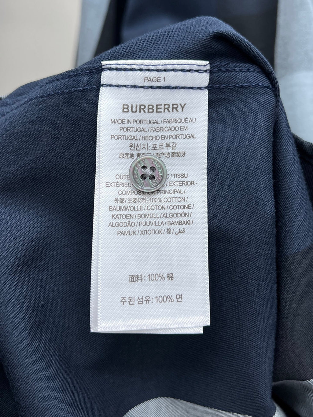 Navy long-sleeve shirt with Burberry care label at the inner collar