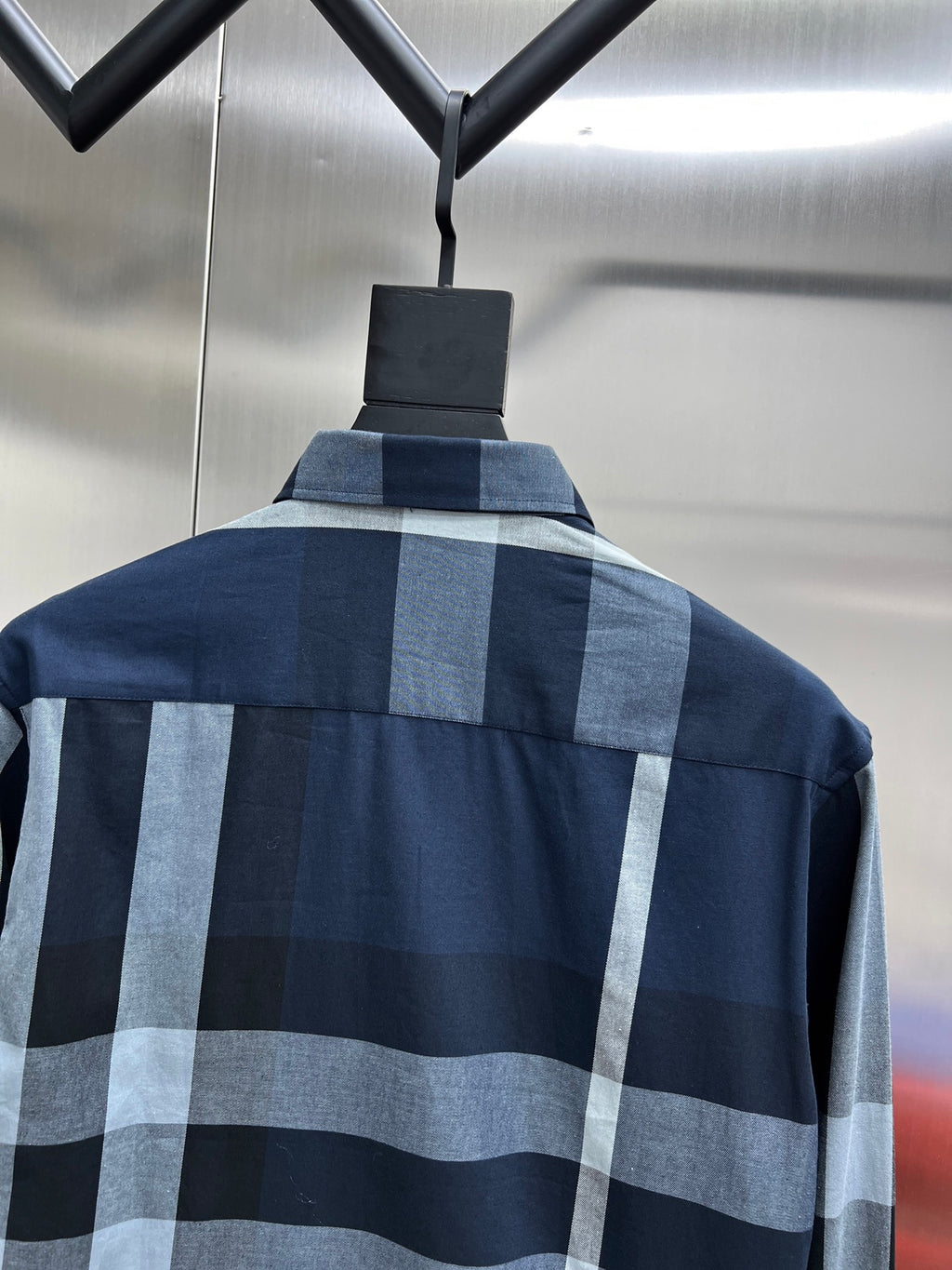 Navy long-sleeve plaid shirt with light blue and gray check pattern and stand collar