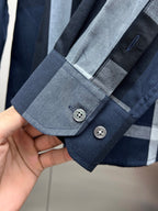 Navy long-sleeve shirt cuff with light blue plaid band and two-button closure