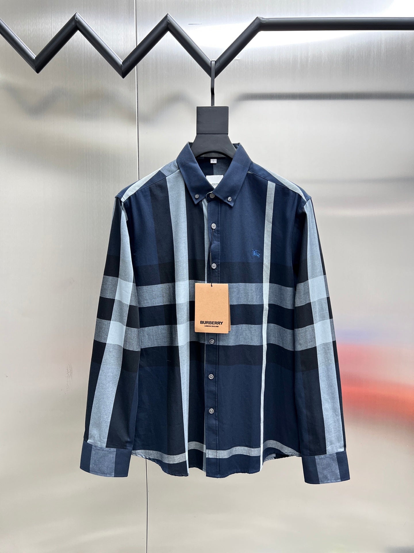 Navy plaid button-up shirt with long sleeves, pointed collar and front buttons