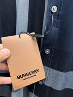 Navy plaid button-up shirt front with buttons and Burberry London England price tag