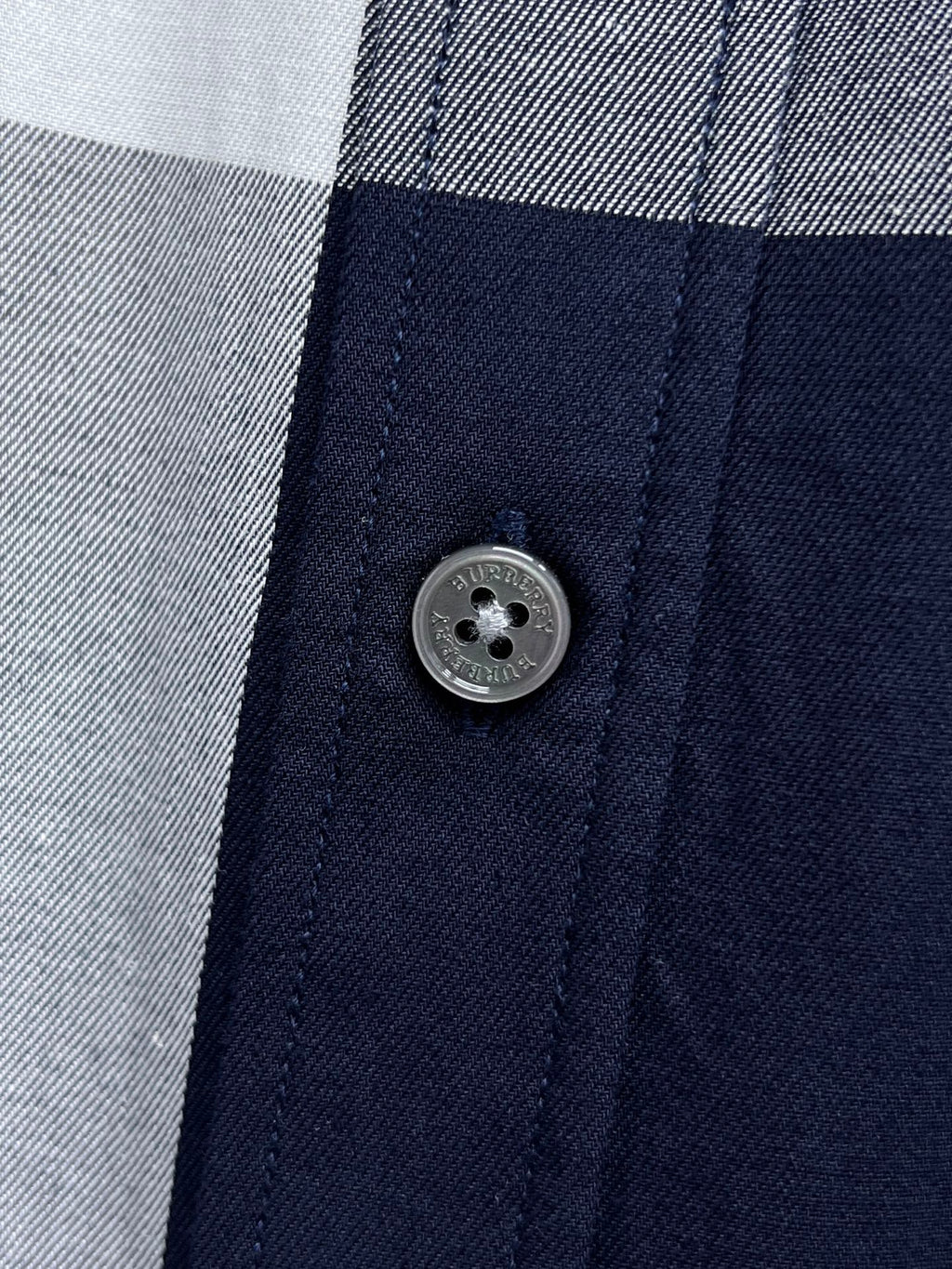 Long-sleeve plaid shirt close-up of front button and placket