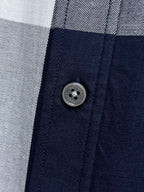 Long-sleeve plaid shirt close-up of front button and placket