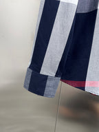 Long-sleeve plaid shirt hem and sleeve cuff, navy and white blocks with red line