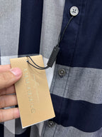 Long-sleeve plaid shirt front with buttons and hanging tan price tag