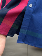 Blue long-sleeve button-up shirt with multicolor plaid pattern and white buttons