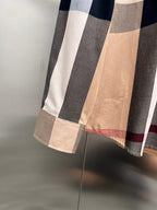 Burberry plaid button-up shirt hem detail in beige with navy, white, and red stripes