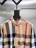Burberry plaid button-up shirt with point collar and gold button front, beige tones