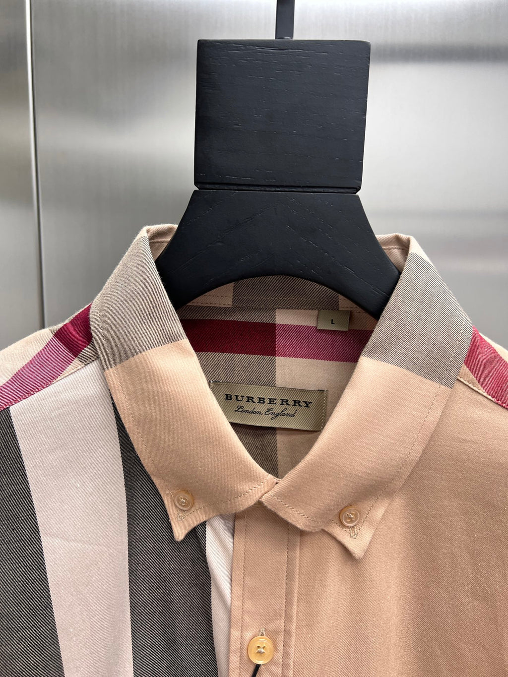 Burberry plaid button-up shirt close-up of tan collar and gold buttons, hanging tag
