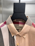 Burberry plaid button-up shirt close-up of tan collar and gold buttons, hanging tag