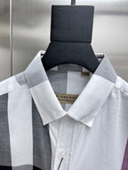 Burberry button-up shirt collar in white, black, and light gray plaid.
