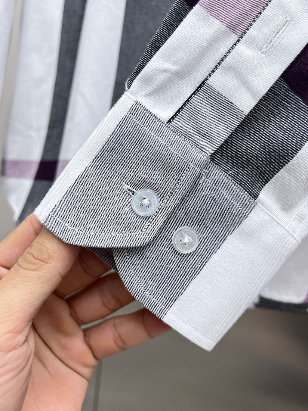 Long-sleeve shirt cuff with two buttons, white, gray, and plum plaid trim