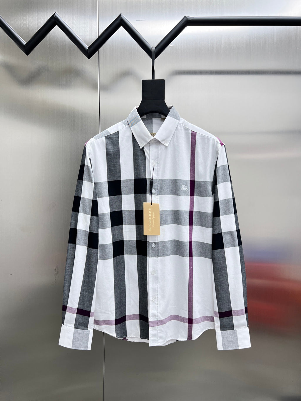 Long-sleeve button-up shirt in white, black, and maroon plaid.