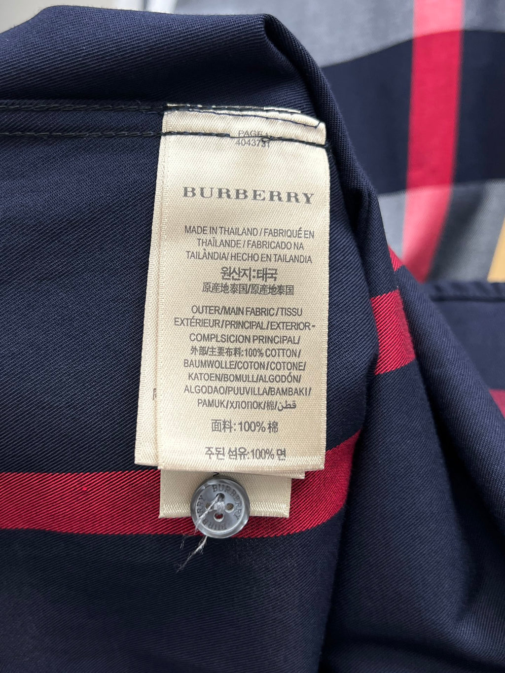 Burberry plaid shirt care label on front with button, navy, red, and gray check