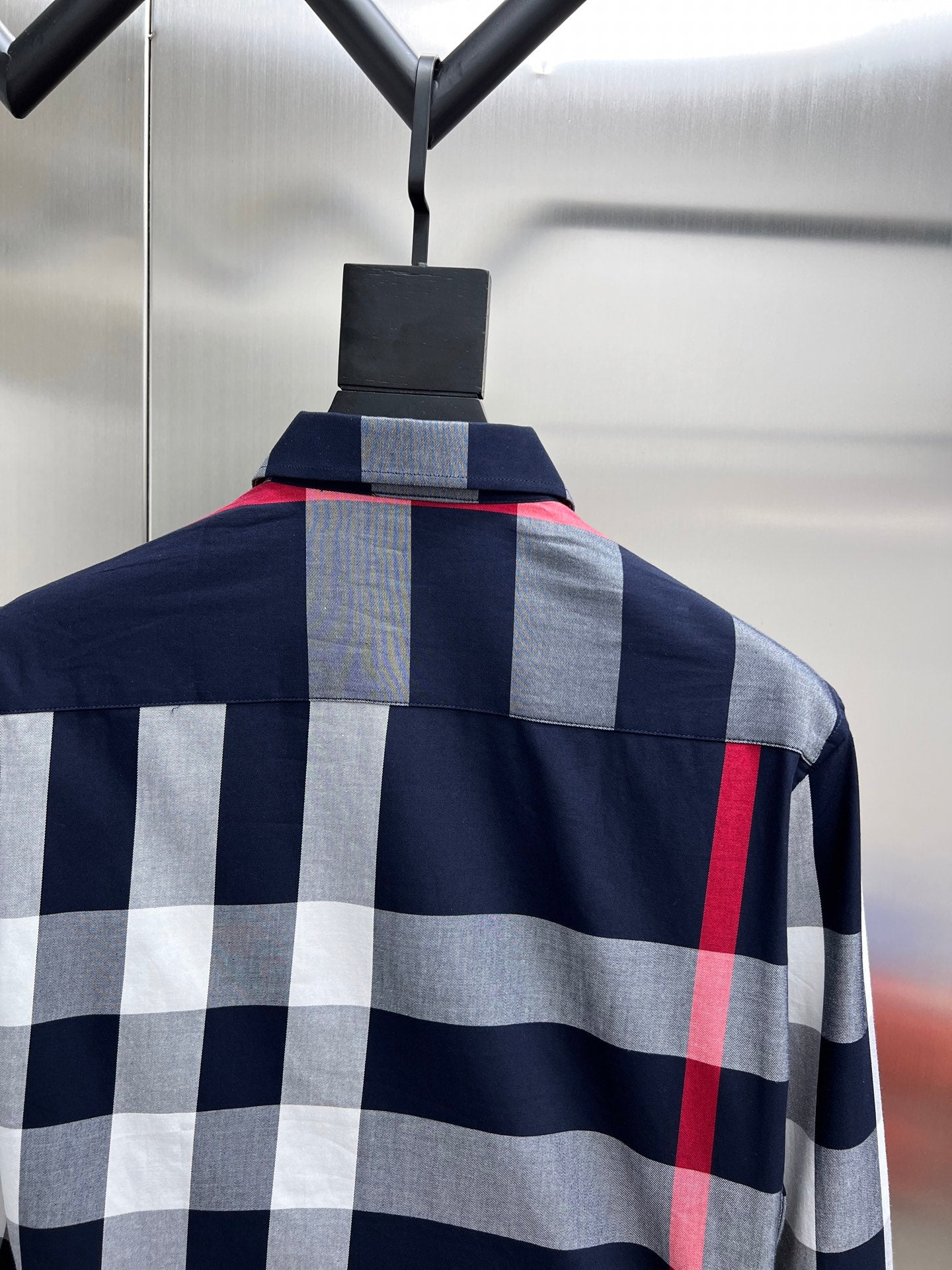 Plaid long-sleeve shirt on hanger, navy with gray and red check