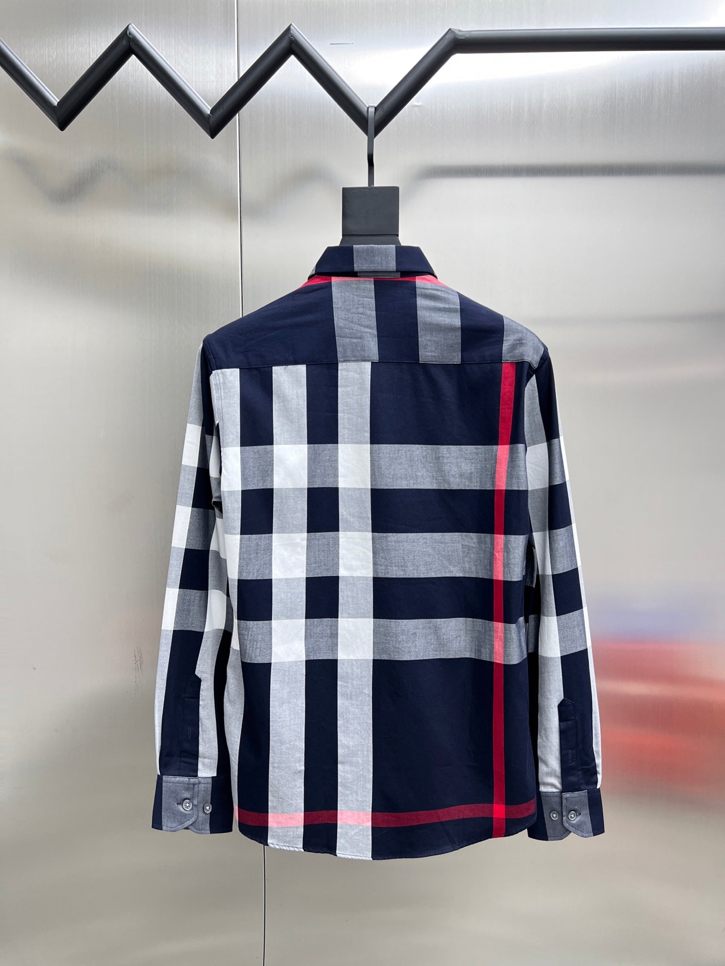 Back view of long-sleeve plaid button-up shirt in navy, white, and red