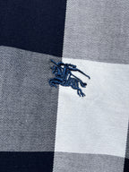 Embroidered horse logo on navy-and-white plaid fabric
