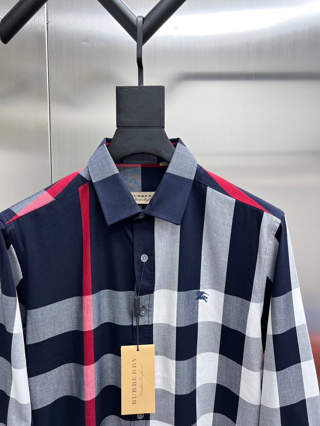 Collared plaid button-up shirt with navy, white, and red stripes