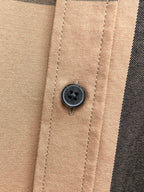 Beige plaid button placket with dark round button