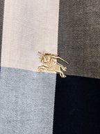 Embroidered Burberry logo on plaid fabric panel