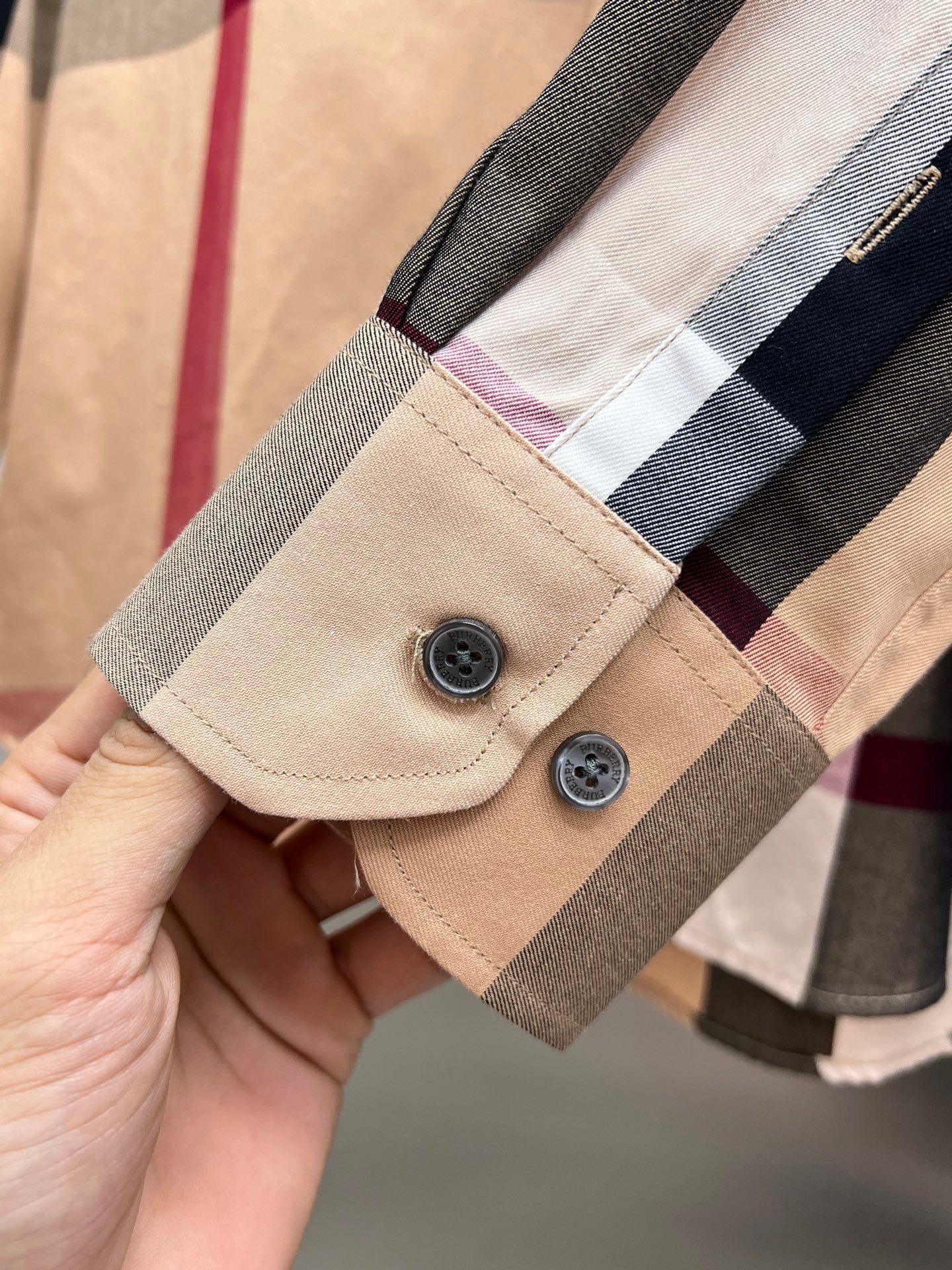 Beige long-sleeve shirt cuff with two-button placket and plaid check trim