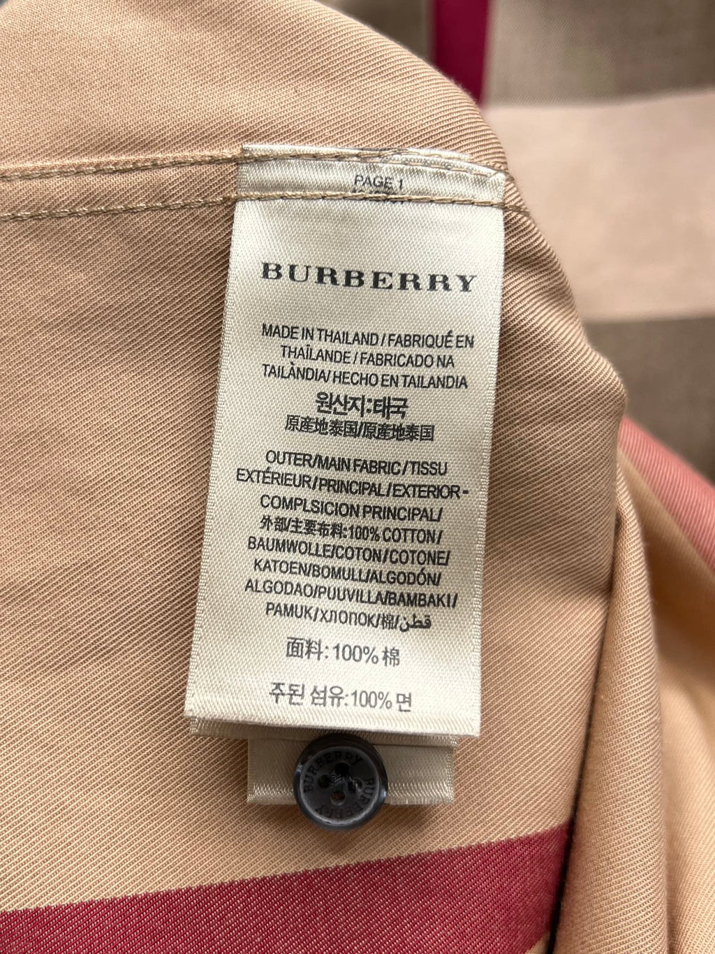 Burberry care label on beige long-sleeve shirt, made in Thailand