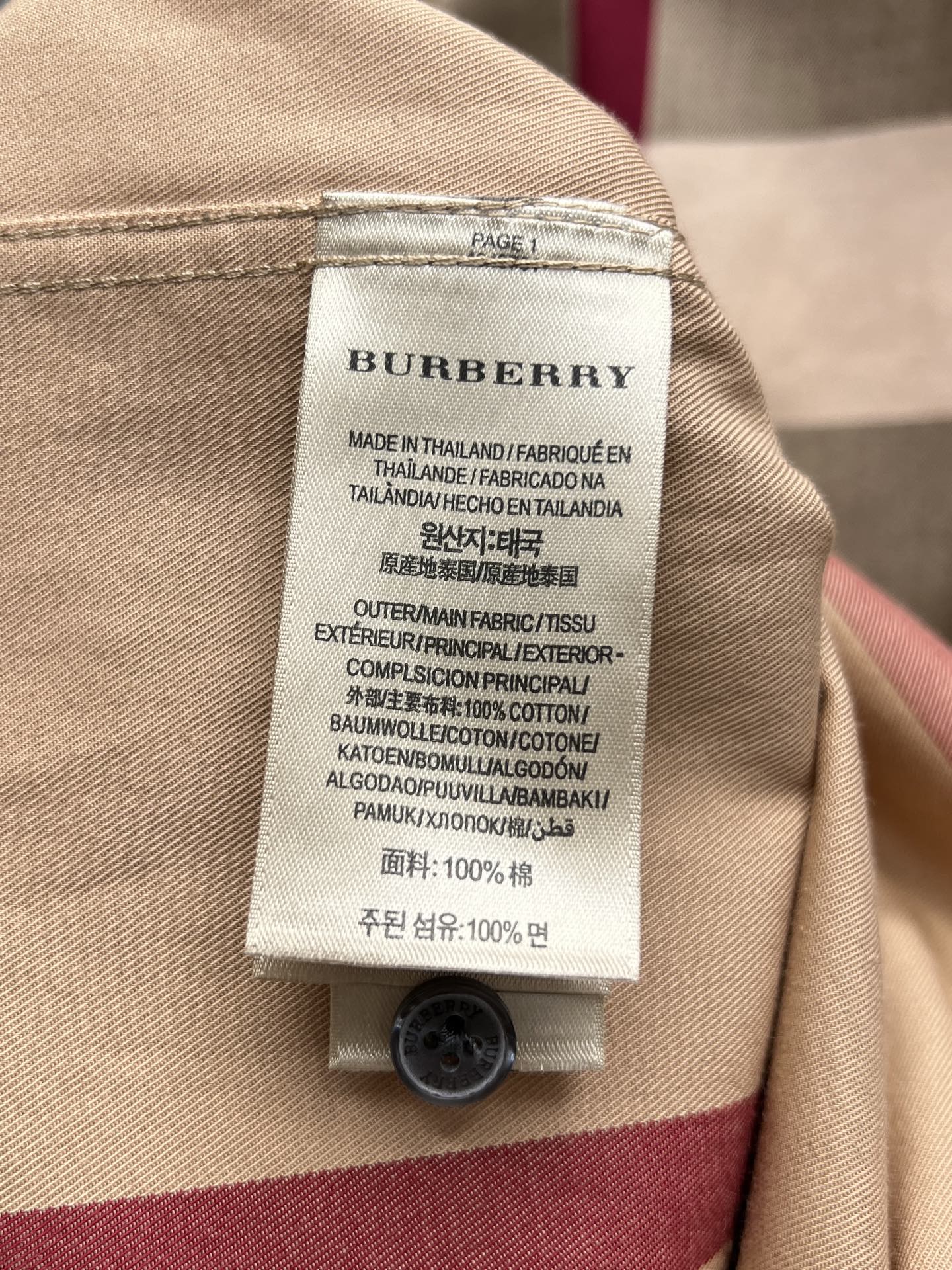 Burberry care label on beige long-sleeve shirt, made in Thailand