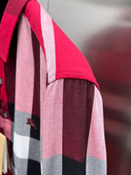 Burberry plaid shirt sleeve detail with red, pink, gray, and dark blocks