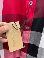 Burberry plaid shirt button placket detail with hanging price tag