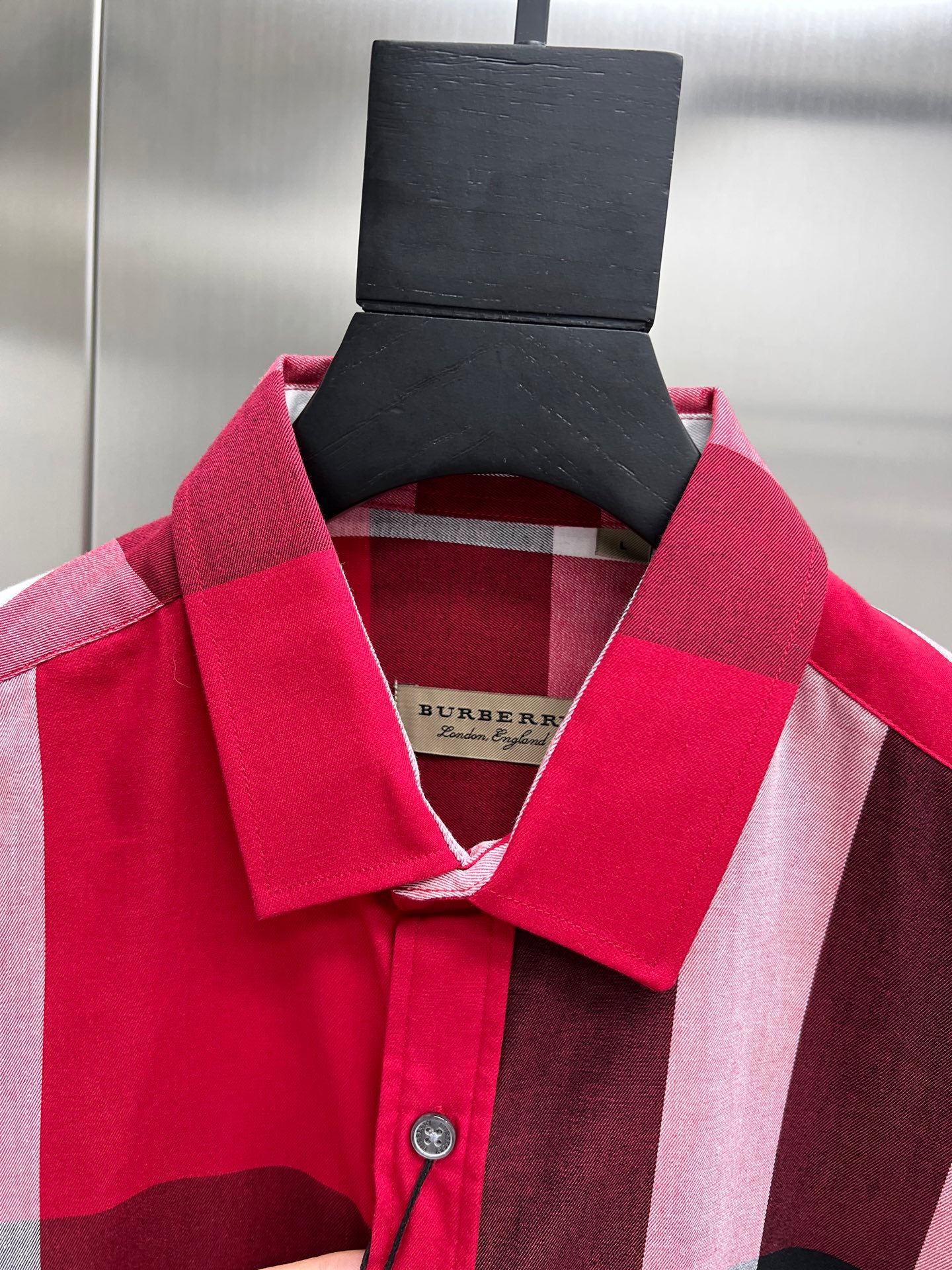 Burberry plaid shirt collar and neckline with hanging product tag