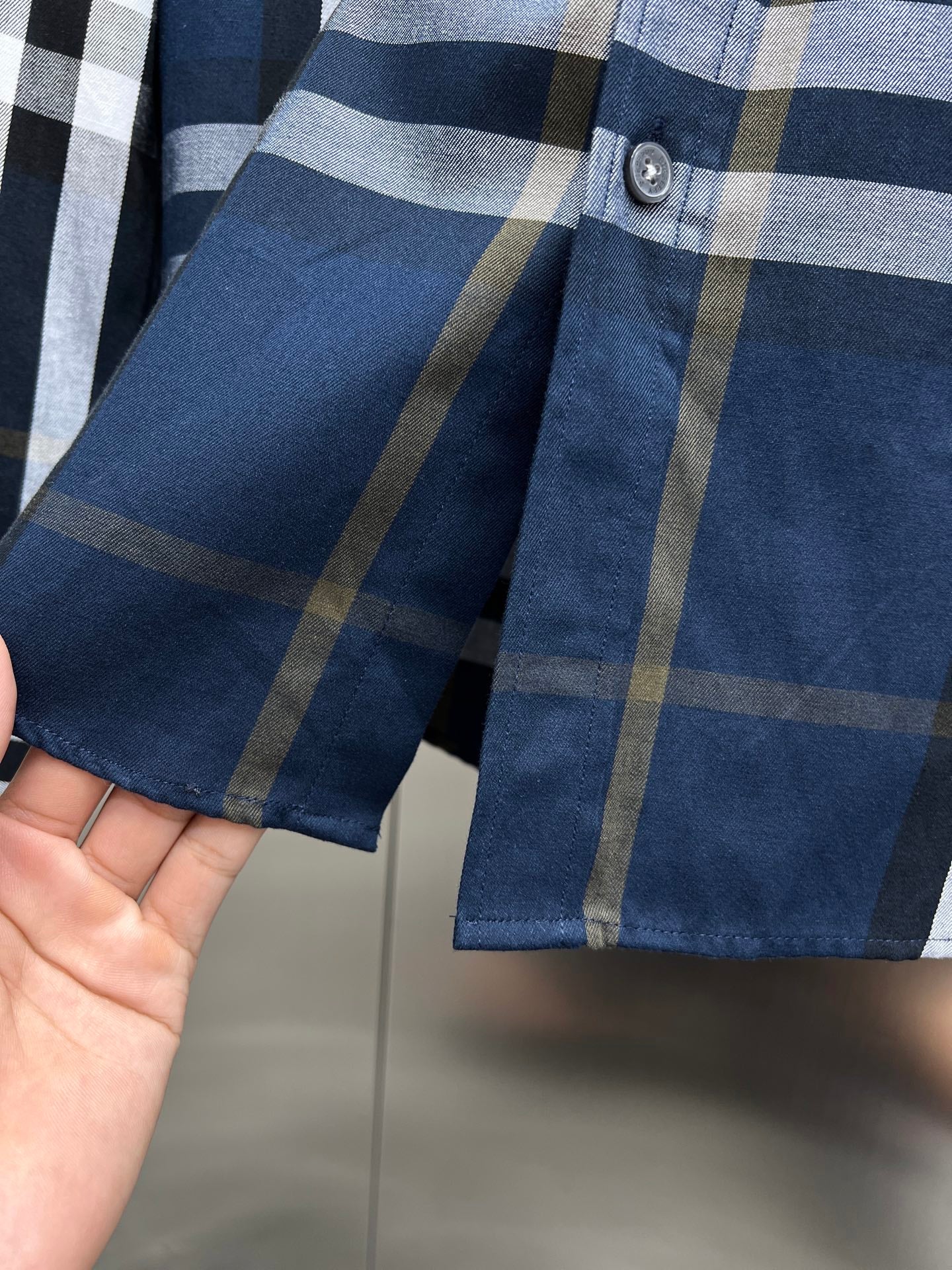 Burberry long-sleeve plaid shirt cuff with two buttons, blue and tan stripes