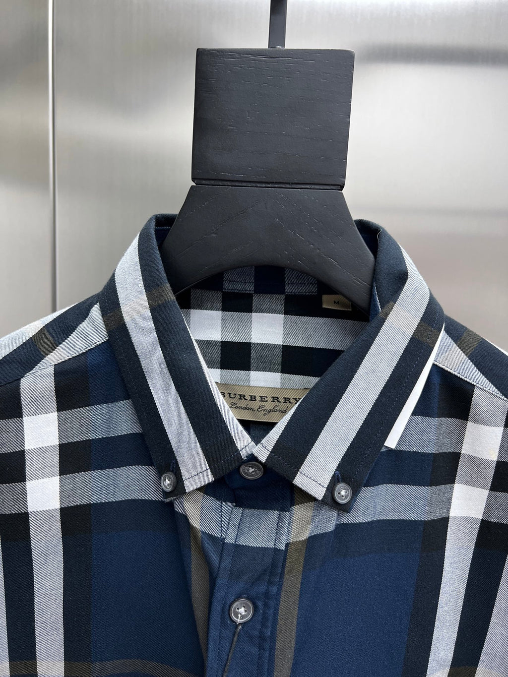 Burberry check shirt collar and placket with round buttons; fabric weave visible
