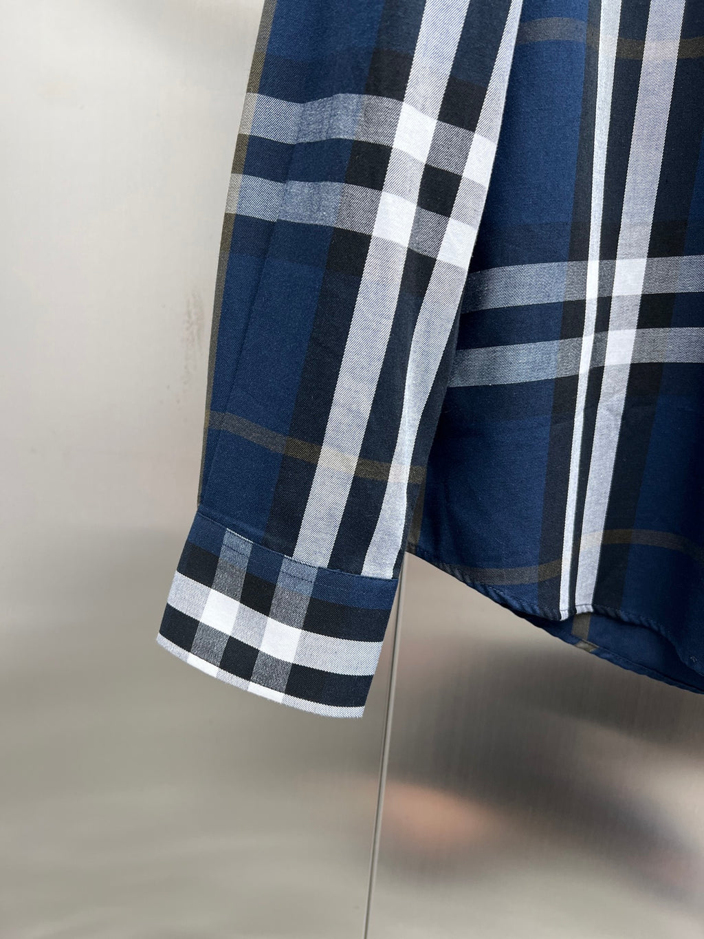 Burberry check button-up shirt side view with blue and white plaid