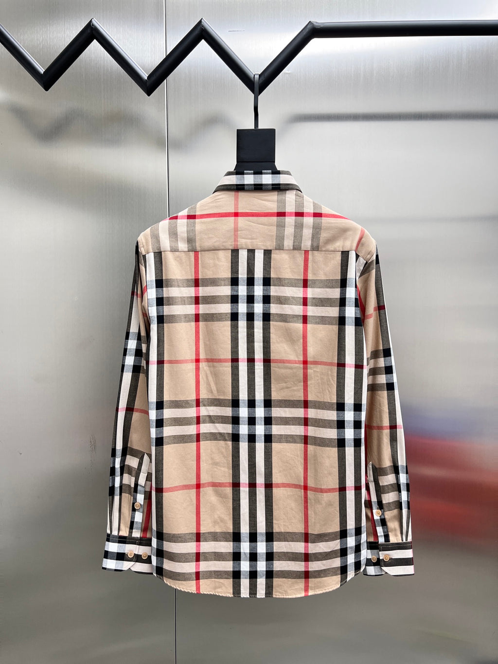 Back view of plaid long-sleeve button-up shirt, beige base with black and red