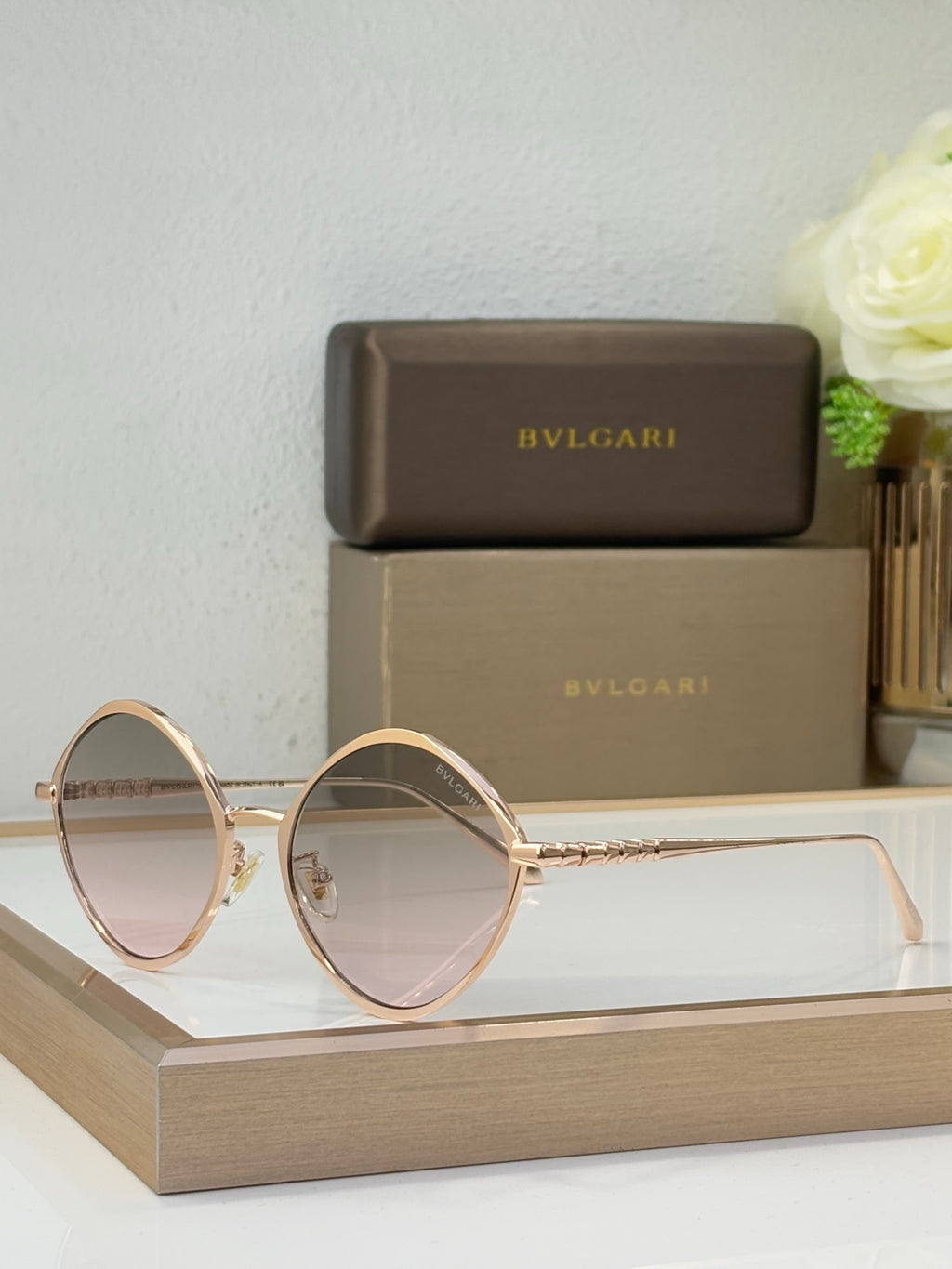Gold round eyeglasses with light tinted lenses and delicate metal bridge