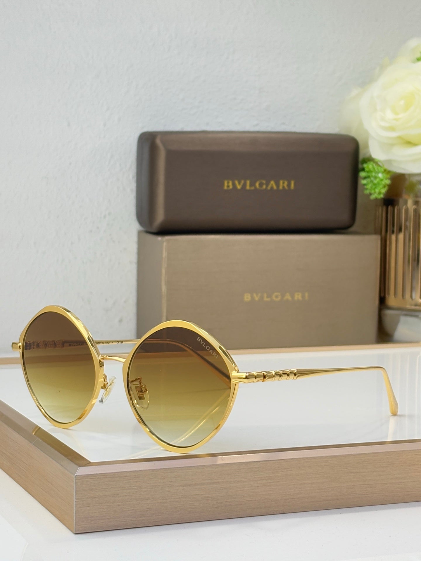 Gold round sunglasses with amber-tinted lenses and thin metal temples