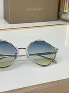 Round silver eyeglasses with blue-tinted gradient lenses and slim bridge