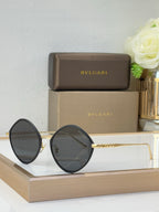 Black round sunglasses with dark lenses and minimal metal arms