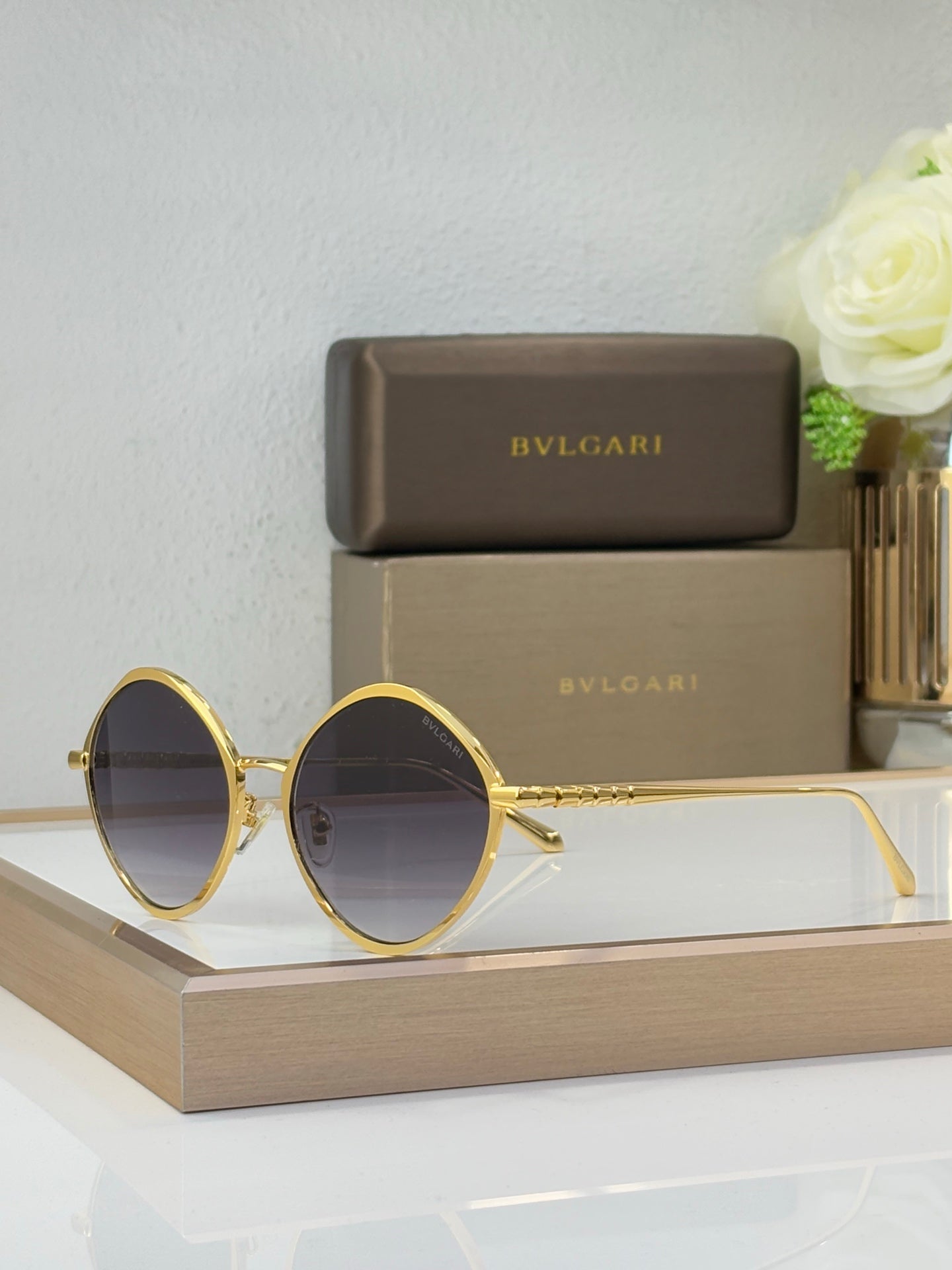 Gold round eyeglasses with dark tinted lenses and slim metal temples