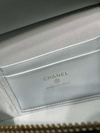 Light blue handbag inner label reading CHANEL and MADE IN ITALY