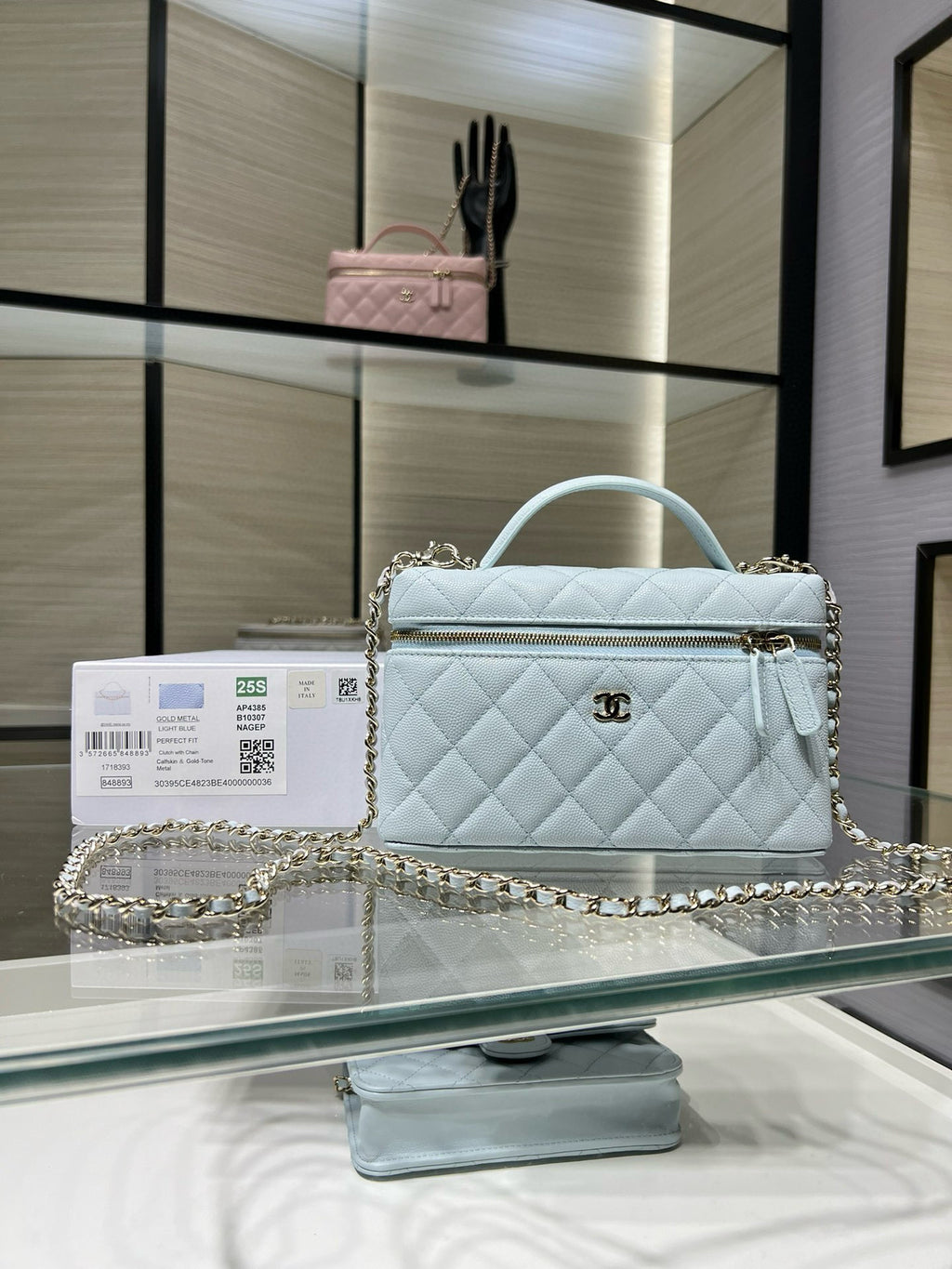 Light blue quilted handbag with gold chain strap and top handle, front flap