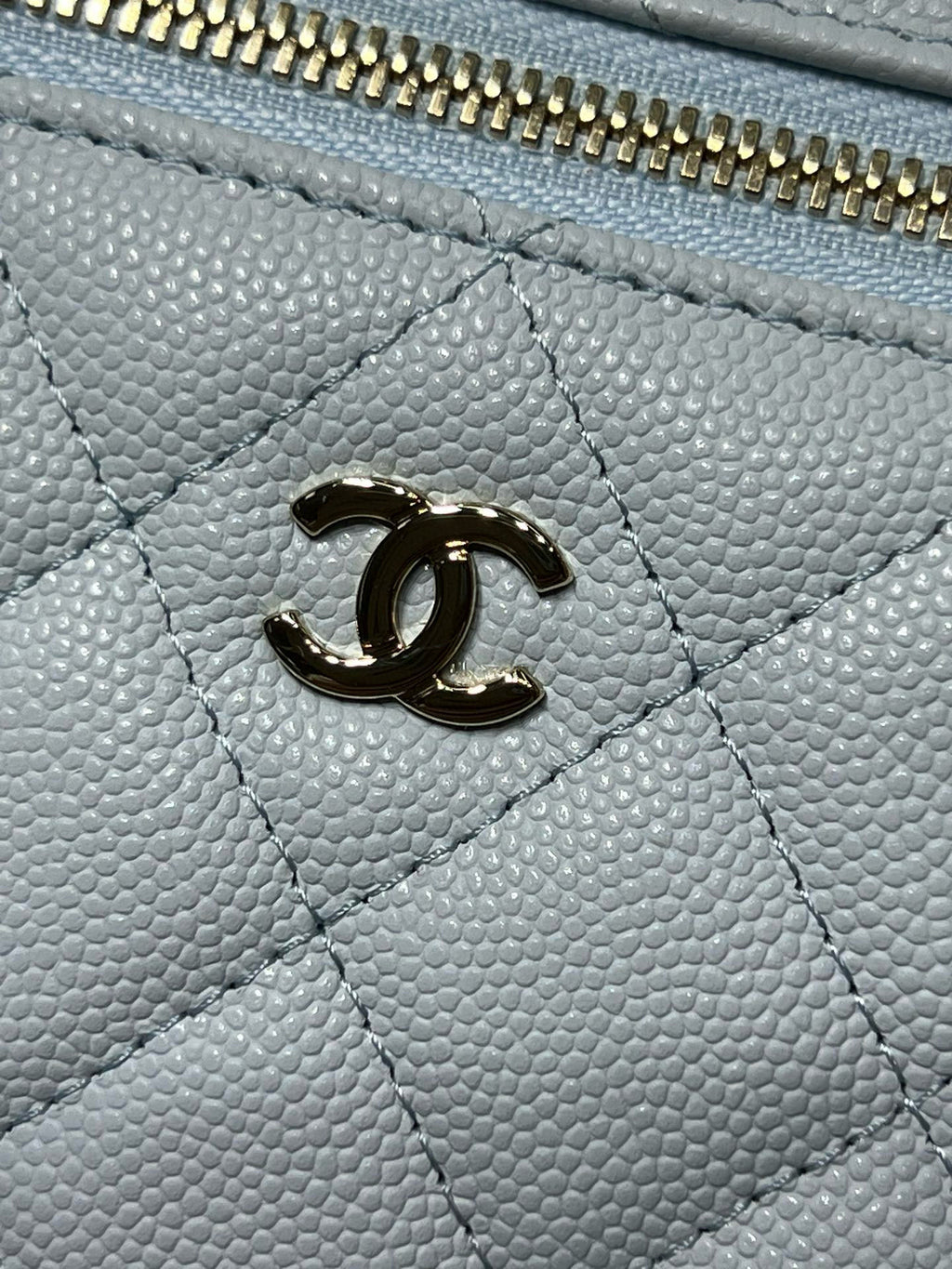 Light blue quilted leather handbag with gold Chanel CC logo and zipper teeth