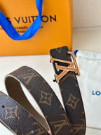 Monogram belt buckle close-up with gold-tone LV on dark brown leather strap.