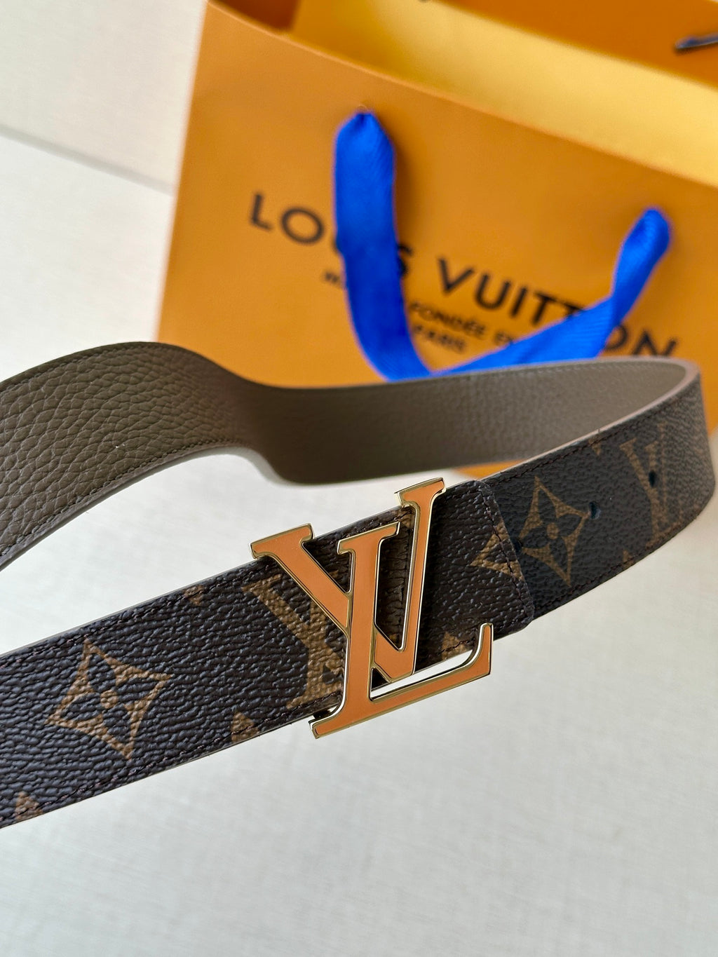 Monogram leather belt with gold-tone LV buckle, dark brown.