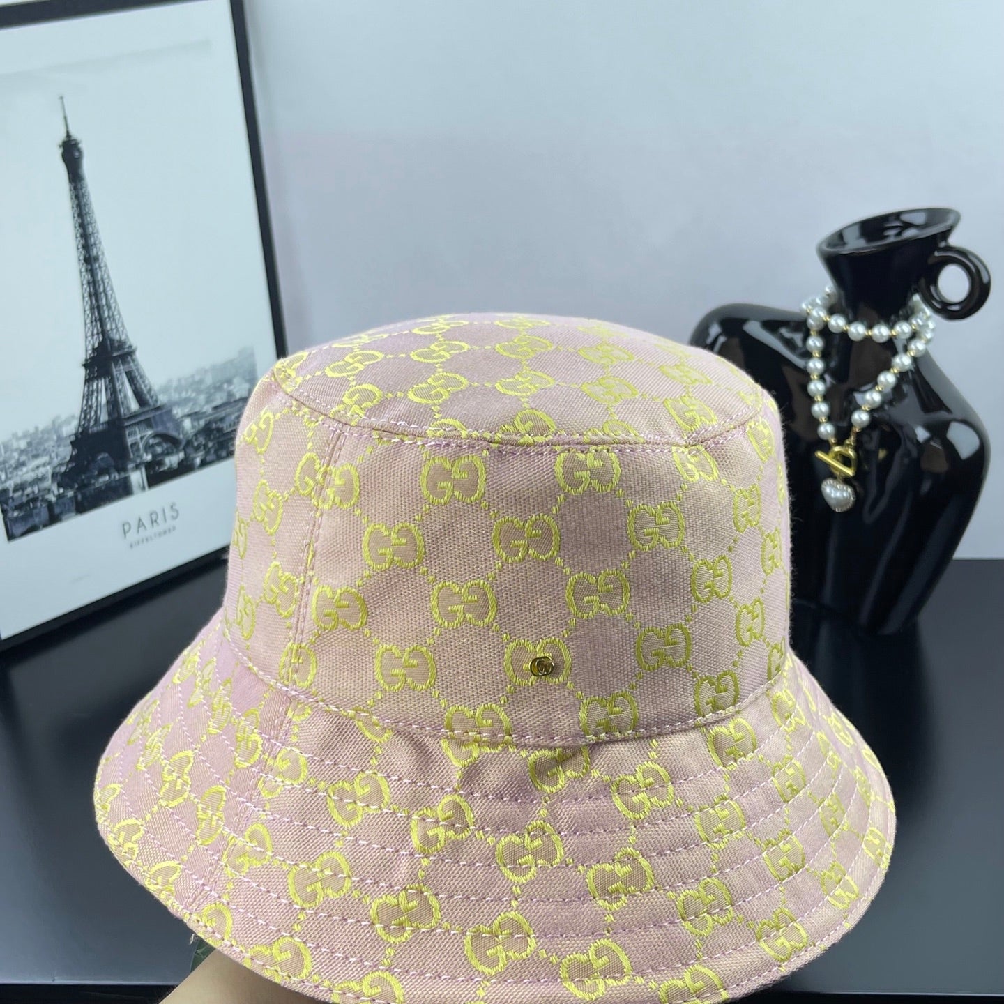 Light purple GG logo bucket hat shown from the side, wide stitched brim
